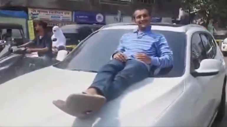 Mumbai boy takes 21-year-old on drive on BMW's bonnet; 2 arrested Mumbai boy takes 21-year-old on drive on BMW's bonnet; 2 arrested