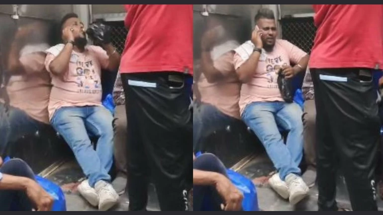Man caught drinking alcohol inside luggage compartment of Mumbai local train.
